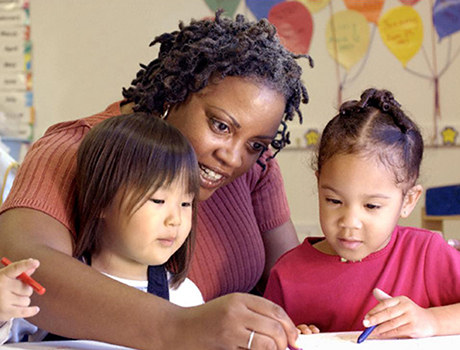 Teacher and students in early education classroom