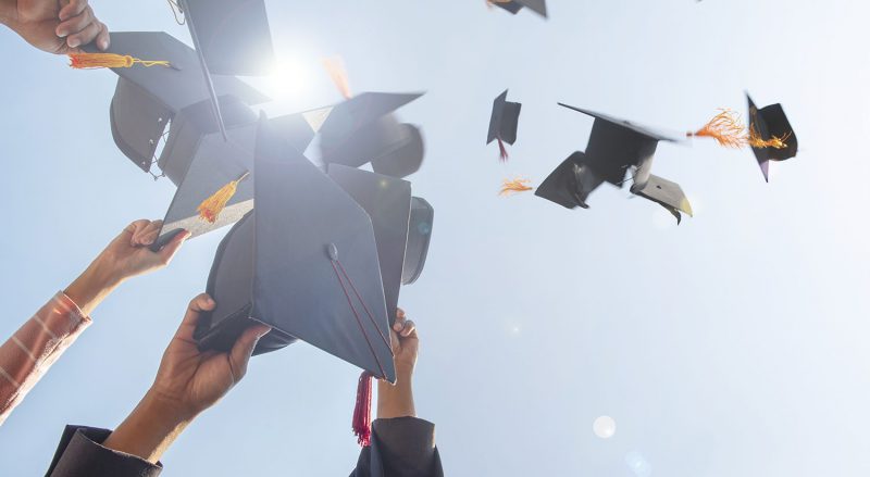 Black hat of the graduates floating in the sky.