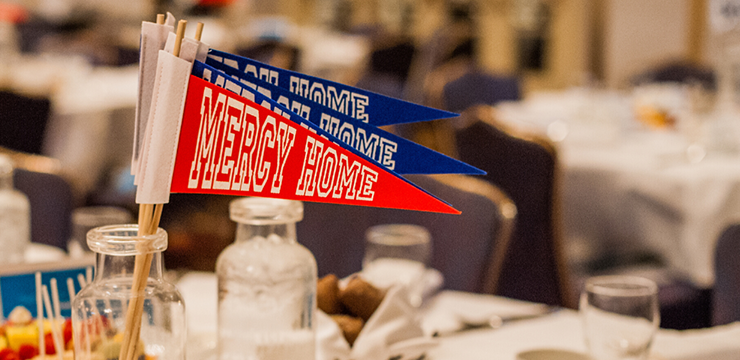 Mercy Home pennants at a conference table