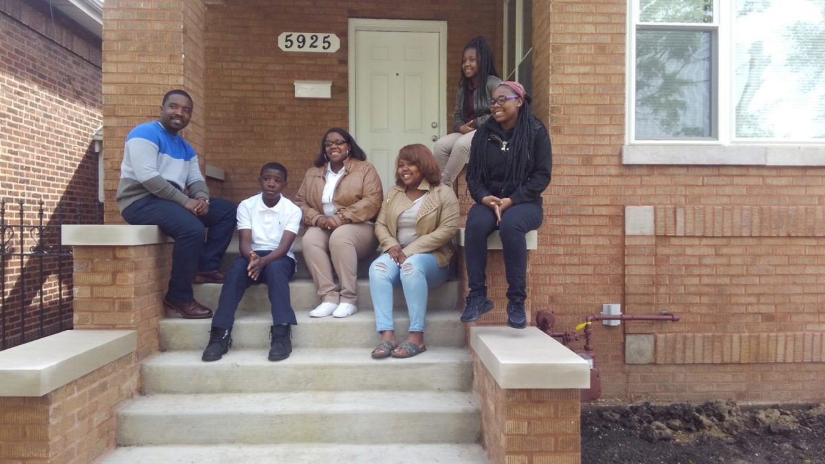 family sitting on front porch